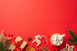 © ActionGP - Christmas concept. Top view photo of wood ornaments pine branches craft paper giftbox wicker star cup of cocoa dried orange slices mistletoe berries cinnamon on isolated red background with copyspace