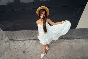 Wall Mural - Cute young woman laughing at the camera