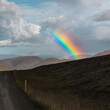 Strong Colorful Rainbow over the mountains on the Road in Iceland