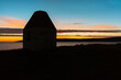 Sunset and Blue Night background with the Sea/Fjord and an Abandoned construction in first plan, in West Iceland