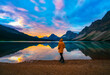 Man On Scenic Mountain Outdoor Lake Shore Getaway At Colorful Sunset Sunrise In Bow Lake Rocky Mountains Canada