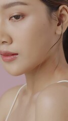 Wall Mural - Vertical footage beauty portrait of young Asian woman with smooth healthy skin.