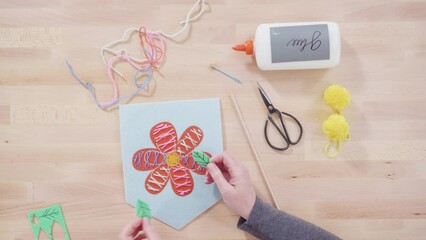 Wall Mural - Flat lay. Little girl learning how to sew with her mother at the craft table.