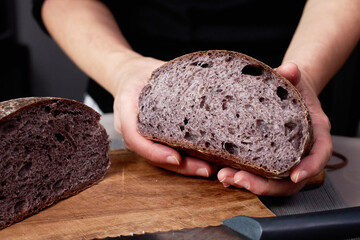 Wall Mural - baker holding artisan rye bread