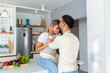 © Graphicroyalty - Portrait of happy young couple cooking together in the kitchen at home. romantic Attractive young woman and handsome man are enjoying spending time together while standing on light modern kitchen.