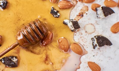 Canvas Print - Closeup of almonds with cookies and wooden honey spoon