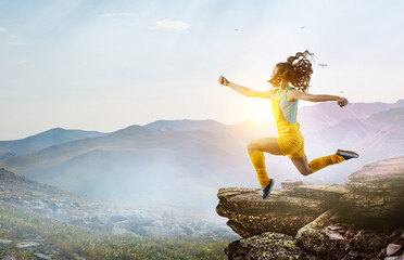 Wall Mural - Young woman jumping in the air