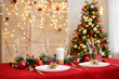 © Di Studio - Decorated table with plates and glasses for christmas dinner