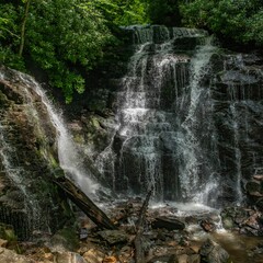 Sticker - Beautiful waterfall falling from mossy rocks in tropical forest