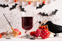A Blood-red Drink For Halloween In The Decorations For The Holiday Of Spider Webs, Bats, Crows, Fly Agarics, Witch's Broom, Skeleton.