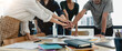Teamwork business concept. Close up view of group of three coworkers join hand together during their meeting.