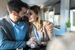 © Panorama - Young couple at meeting with marriage consultant in her office. They look happy and smiling, hugging