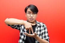 Asian Young Students Happily Using Sign Language Isolated On Red Background.