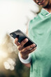 © C Coetzee/peopleimages.com - Sports, exercise and hand of man with phone to check steps, health and fitness tracker or workout support app. Tech, cardio and black runner review his marathon training progress on mobile smartphone