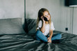 © F8  \ Suport Ukraine - little girl on bed with cell phone at home