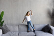 © F8  \ Suport Ukraine - Beautiful little girl jump and has fun on sofa in the room