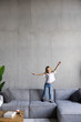 © F8  \ Suport Ukraine - Adorable small little girl jumping at home on sofa