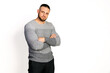 © oleg_ermak - Friendly young man in gray knit sweater cross hands on breast. Copy space white background. Autumn-winter clothing collection