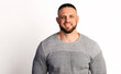 © oleg_ermak - Close-up portrait of smiling handsome man in gray sweater isolated on white background