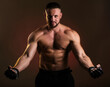 © oleg_ermak - Studio portrait of fighting muscular man in black fighting gloves posing on dark background. The concept of mixed martial arts. Brutal bodybuilder energy and power boxing.