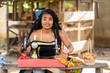 image of beautiful african lady with a working tool- local black seamstress outdoor