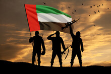 Silhouettes Of Soldiers With The Flag Of UAE On Background Of The Sunset Or The Sunrise. Commemoration Day.