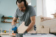 A carpenter makes children's furniture in a carpentry workshop