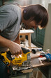 © dsheremeta - A wood-worker using a jigsaw to cut out a curve in a work piece of pine.
