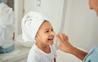 © David L/peopleimages.com - Skincare, cream and girl child at home with mother with a happy smile in a bathroom. Happiness of a kid and mom using face lotion, skin wellness and youth morning beauty routine at a family house