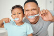 © David L/peopleimages.com - Portrait of dental dad, kid brushing teeth and healthy mouth cleaning in home bathroom. Happy father teaching child oral healthcare, wellness and fresh breath with toothbrush, toothpaste and smile