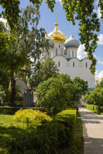 Greenery, Orthodox Church With Golden Domes And Holy Scrosses Of Novodevichy Convent In Moscow. Chapel And Crypt From The Side.