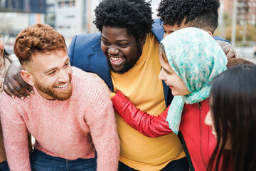 Wall Mural - Young happy people having fun outdoor together - Focus on african curvy man face