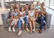© Alexis Scholtz/peopleimages.com - Big family, portrait and happy smile relax on sofa enjoying bonding time together in the living room at home. Mother, father and children with their grandparents relaxing on couch in happiness