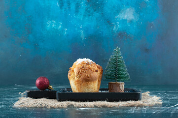 Wall Mural - Delicious muffin with Christmas small tree and ball