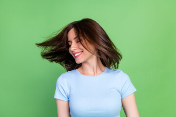 Wall Mural - Photo of gorgeous cheerful girl closed eyes toothy smile flying hair isolated on green color background