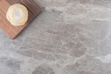 A Flaky Cookie On A Board On Marble Background