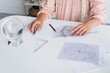 cropped view of astrologer drawing celestial map at home.