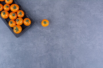 Wall Mural - Yellow cherry tomatoes isolated on blue background