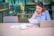© photobyphotoboy - Asian business woman working using  laptop for do math finance on wooden desk, tax, accounting, statistics and analytical research concept