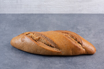 Sticker - Single loaf of baton bread on marble background