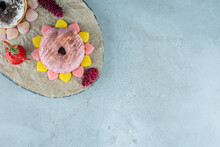 Glazed Donuts Encircled With Marmelades On A Wooden Board On Marble Background