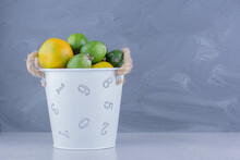 Bucket Of Tangerine And Feijoa On Marble Background