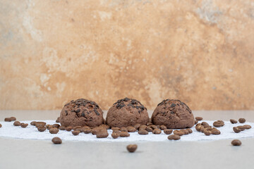 Chocolate cookies with coffee beans on white background