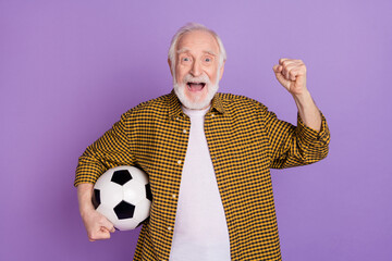 Poster - Photo of cheery granddad grey hair fan soccer team fist raised dressed stylish yellow plaid shirt isolated on lilac violet color background