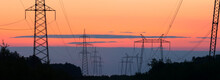 Wide Panorama Of Power Lines Against The Sky Of Sunrise Colors