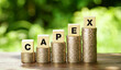 CAPEX letter blocks and stack coins, business concept. CAPEX stands for Capital Expenditure.        