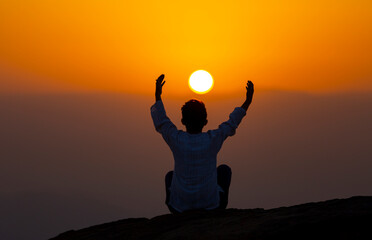 People praying to god at sunset.