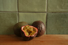 Two Passion Fruits In The Kitchen With One Half