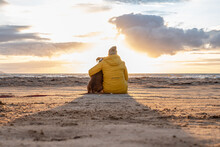 A German Boxer Dog Sitting On The Seashore During Sunset With Owner Blonde Girl Team Partner Friend Sweden Melbystrand