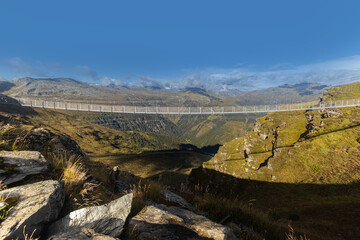 Alpine suspension metal bridge over a precipice at an altitude of 2200 meters in the Alps. Austria, Salzburg, Gastein